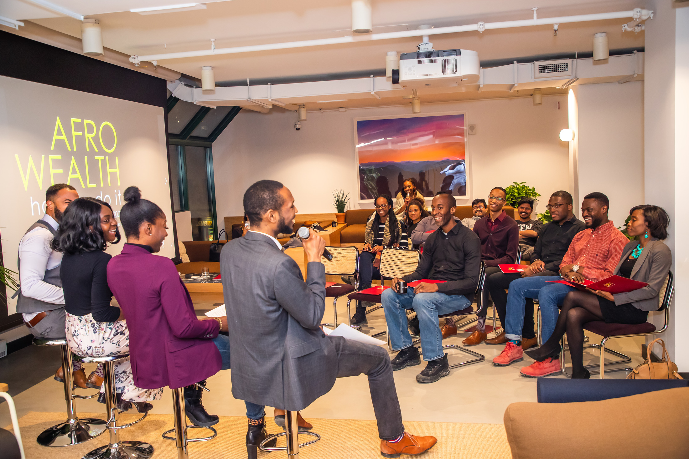 Panel talk in front of an audience and a projected screen