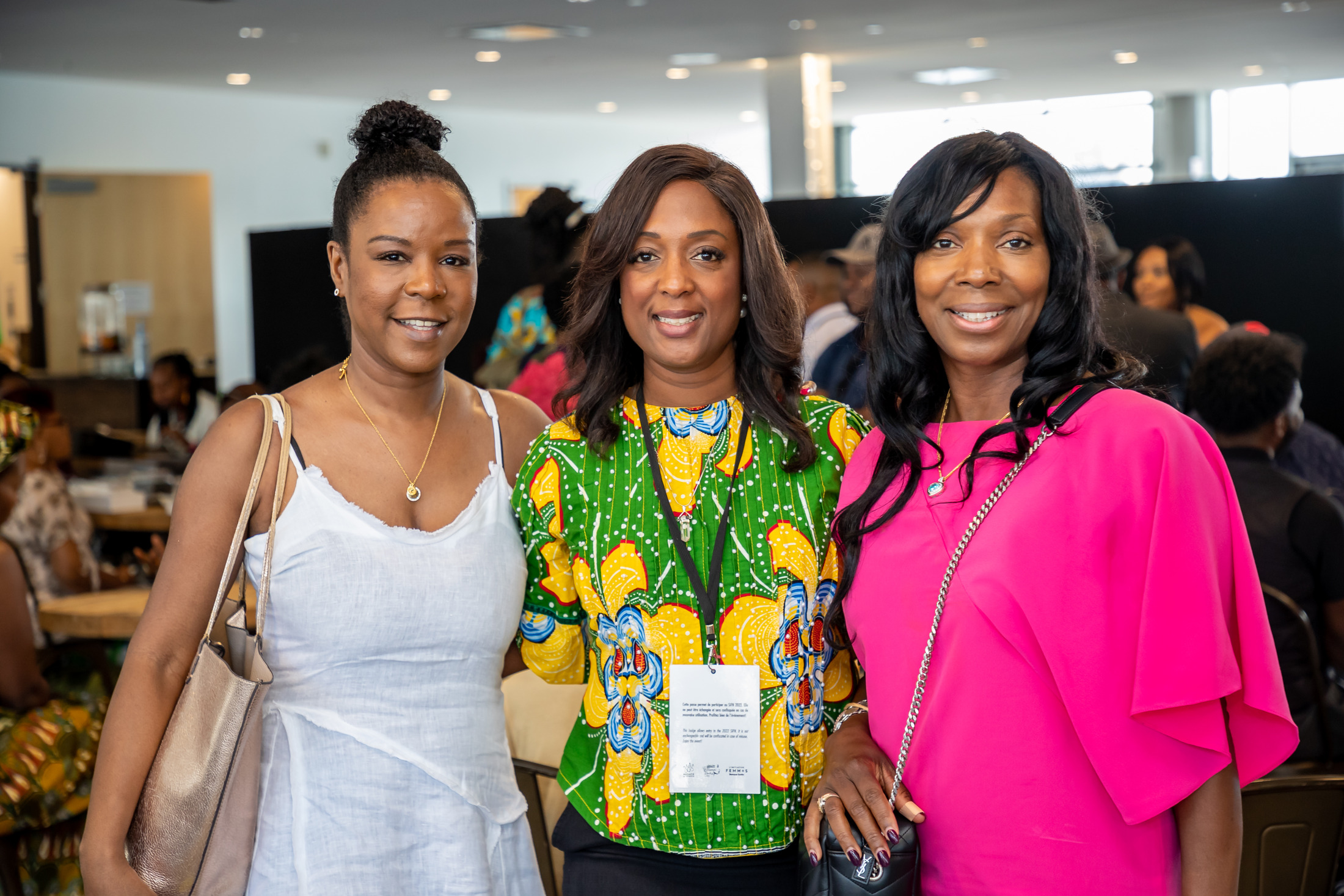 Three women posing together at an event