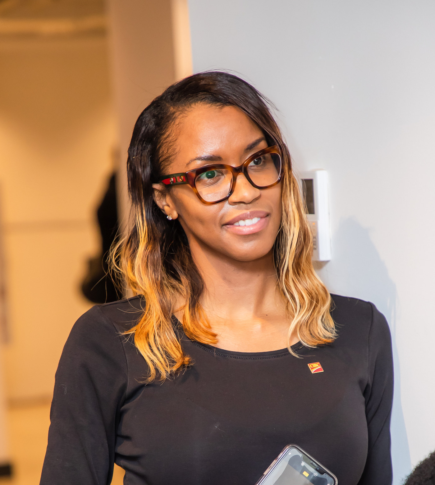 Woman in glasses smiling at an event